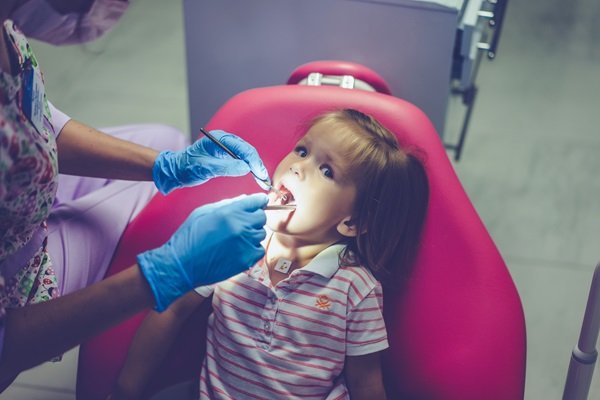 pediatric dentist. Little girl at the reception at the dentist.